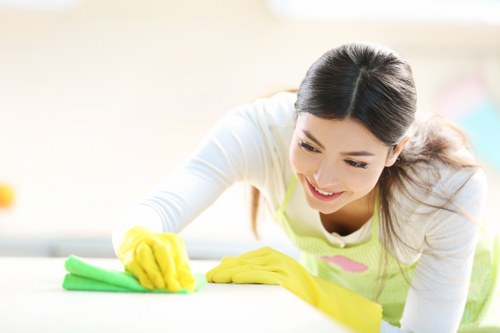 Cleaner mopping a corridor in a shared residential building